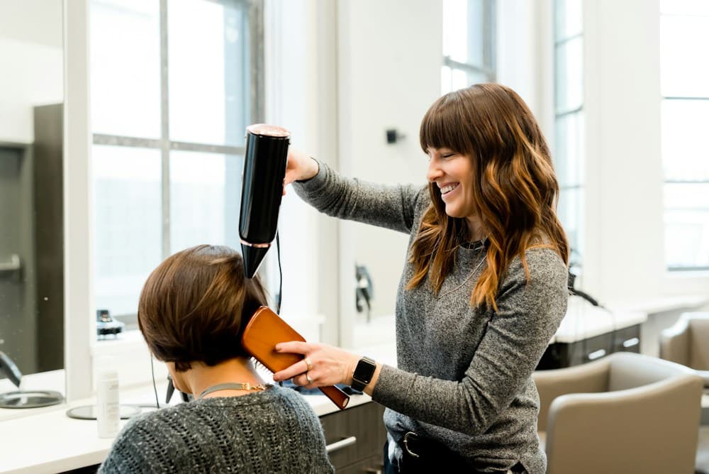 A stylist carefully shaping a haircut