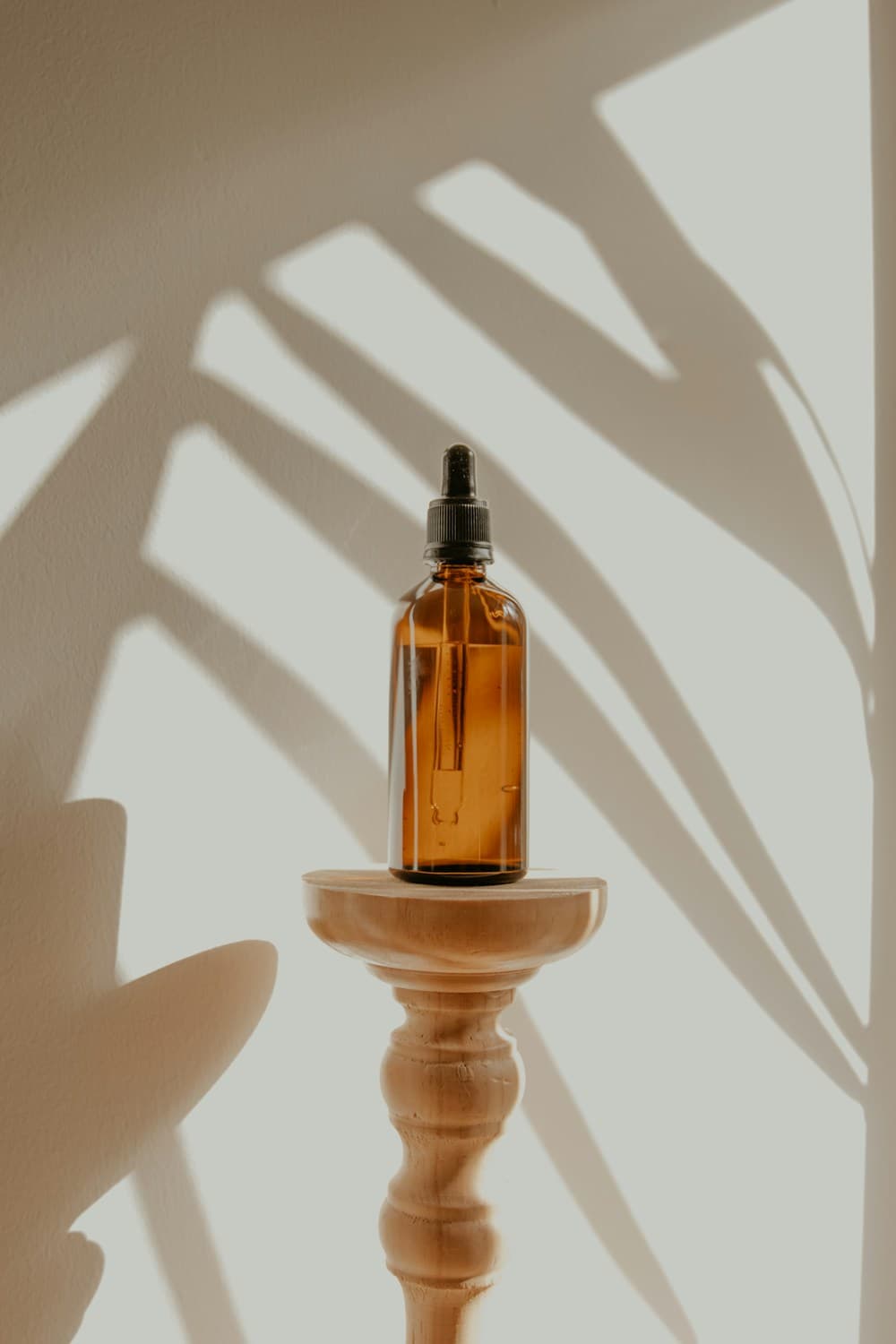 A glass bottle of botanical care oil